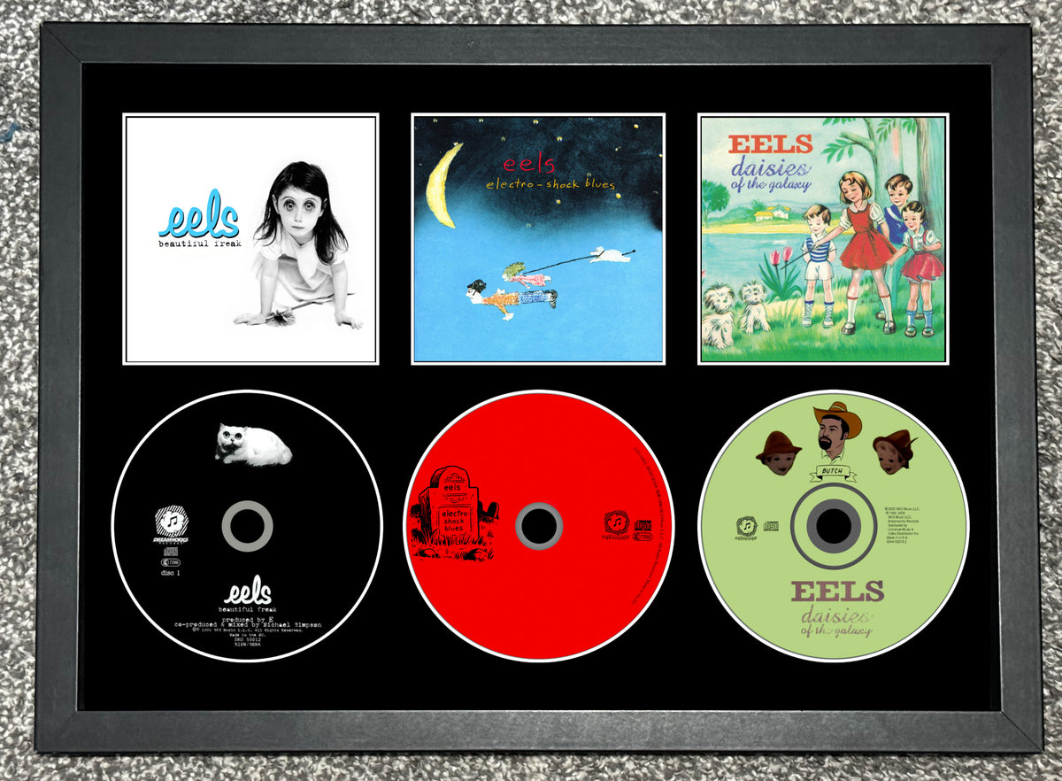 Eels | Beautiful Freak | Electro-Shock Blues | Daisies Of The Galaxy | Triple Retro Mounted CD Wall Display | Frame Not Included |